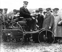 Carl Benz con uno de sus coches a finales del siglo XIX